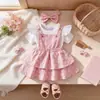 Ropa para niñas europeas y americanas: Enterizo triangular de manga abullonada + falda pastel con tirantes florales + diadema, un conjunto de tres piezas de la fábrica original