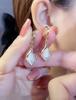 Pendientes de gota de piedra de ojo de gato con diseño de gancho para la oreja avanzado, estilo nuevo japonés y coreano, ligeros y elegantes.