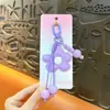 Llavero colgante de flor de aleación creativa para bolso, pequeño colgante de cuerda tejida estilo Miu, accesorio para bolso, venta al por mayor de regalos