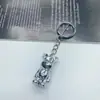Llavero de oso violento de muñeca 3D de moda en internet, llavero creativo de metal para coche, colgante de oso de dibujos animados con líquido, venta al por mayor