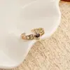 Anillo retro floral en tono café dorado, una pieza lujosa y única con un aire de alta gama, diseñado para apilar, con un borde de encaje, y perfecto para el dedo índice, ofreciendo un estilo moderno e individual