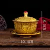 Conjunto de Chá de Latão de Três Peças: Tigela com Tampa Cinco Bois, Tigela com Tampa Cem Bênçãos, Xícara de Chá Embossada Dragão e Fênix