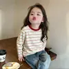 Camiseta de manga larga a rayas de algodón puro para niña 2026 primavera y otoño nueva, top casual versátil, camiseta interior básica de cuello redondo estilo coreano para niños