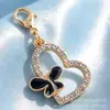 Varios colgantes de aleación en forma de corazón negros y dorados, llaveros giratorios de pinza de langosta dorada, dijes para bolsos y accesorios de joyería - al por mayor