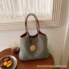 Bolsa tejida de venta caliente de verano para mujer, nuevo diseño 2026, estilo nicho, bolso de hombro de paja para vacaciones en la playa