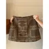 Saia de camurça bordada francesa para mulheres, nova coleção outono/inverno 2026, cintura alta, corte A, anti-exposição, curta, estilo bodycon, 14263