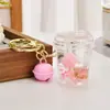 Lindo llavero de botella de arena movediza con gato KT, gatito de dibujos animados creativo, colgante para mochila escolar de estudiante, llavero para coche, baratijas