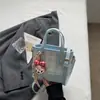 Bolso de mujer de nicho de alta gama 2026 nuevo bolso cruzado de moda a cuadros estilo coreano moderno bolso tipo cubo