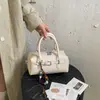 Bolsa Boston de alta gama para mujer, nuevo modelo de verano 2026, diseño de hebilla de cinturón exclusivo, bolso de hombro moderno y a la moda