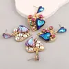 Nuevos pendientes de aleación huecos de moda con forma de corazón Super Flash transfronterizos europeos y americanos, pendientes con incrustaciones de diamantes de colores para el Día de San Valentín para mujer