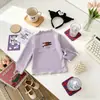 Camiseta base de manga larga para niñas con volantes y cuello semialto de dibujos animados, otoño para niños pequeños y niños, ropa interior infantil al por mayor