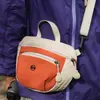 Atacado transfronteiriço nova bolsa de mão coreana de nicho com cor contrastante bolsa de sela de lona bolsa de ombro único transversal bolsa de celular para atividades ao ar livre