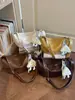 Bolso grande de mujer retro casual 2026 verano nuevo color liso bolsa de albóndiga simple para el trabajo hombro bandolera
