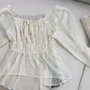 Notas acuáticas claras y frías de pedo Color albaricoque de arroz Camisa de gasa con borde de oreja de madera de un solo hombro para mujer Top corto de primavera y verano Falda corta 11141