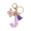 Llavero de Resina con Alfabeto Inglés A-Z Colgante de Borla de Mariposa Morada Colgante para Bolso de Mujer Llavero de Coche