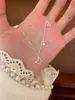 Colar de pérolas em formato de borboleta estilo coreano, novo design de nicho, moderno e único, corrente de clavícula floral versátil e elegante
