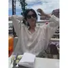 Ropa del mismo estilo de Song Hye-kyo, nueva camisa larga de manga larga suelta y ligera de primavera-verano, camisa protectora solar, camisa blanca de rayas verticales para mujer