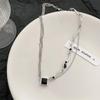 Novo estilo hot girl personalizado colar de zircão preto feminino borla assimétrica cadeia de clavícula de metal colar retrô