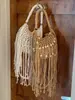 Bolso tejido para mujer, nuevo modelo de verano 2026, bolso de hombro niche y súper popular para el día a día, bolso cruzado con flecos, bolso de playa de paja