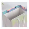 Bolsa de regalo láser creativa colorida personalizada de fábrica, bolsa de papel portátil tridimensional para publicidad de ropa y compras, impresión de logotipo