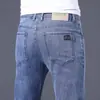Jeans masculinos de alta qualidade para primavera e verão, corte reto, caimento slim, elástico, calça longa moderna de Guangzhou Xintang, estilo versátil de verão