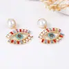 Pendientes de aleación con diseño creativo de alta gama, segunda mano, de lujo ligero, europeos y americanos, con ojo de diablo de diamantes completos y perlas de imitación
