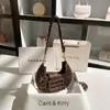 Entrega en una sola pieza moda todo-partido tejido bolsa de axila 2024 nicho moda hombro bolsa de media luna al por mayor