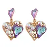 Nuevos pendientes de aleación huecos de moda con forma de corazón Super Flash transfronterizos europeos y americanos, pendientes con incrustaciones de diamantes de colores para el Día de San Valentín para mujer