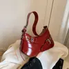 Bolsa de Ombro Fashion e Sofisticada para Mulheres Verão 2025 Versão Coreana Tendência Versátil Bolsa para Motociclista Simples de Nicho para Mulheres