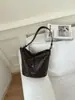 Bolso de cubo con patrón tejido de moda transfronterizo para mujer, nuevo bolso de axila de nicho de alto valor, bolso de hombro moderno para ir al trabajo y salir
