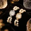 Venta al por mayor de relojes elásticos de cuarzo con perlas artificiales de doble fila en stock, relojes de pulsera con incrustaciones de diamantes transfronterizos y relojes de mujer con estampado floral