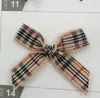 Venta al por mayor del fabricante Cinta a cuadros de 1 cm con lazo Accesorios para ropa Hecho a mano DIY Caja de regalo Lazo para lencería