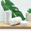Venta al por mayor del fabricante 60 ml Botella de plástico de bambú para producto de cuidado de la salud Tapa de rosca a presión Botella para envasado de polvo de tabletas Sello