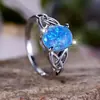 Deseo transfronterizo AliExpress moda viajero Palladium Blanco K forma de huevo borde de ópalo azul anillo cruzado suministro de fábrica al por mayor