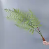 Plantas verdes artificiales en stock, manojos de helecho, hojas de helecho, hierba de helecho para decoración de paredes interiores y diseño de paisajes, césped artificial al por mayor