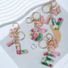 Suministros del Fabricante Llaveros con Flores Secas Prensadas 26 Letras del Alfabeto Inglés Llaveros con Borla de Mariposa Charms para Bolsos de Mujer