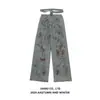 Jiamu Entra en Escena para Probar Jeans Holgados Estilo Wasteland Tejido Calado Cordón Jeans Pintados con Spray de Industria Pesada para Hombres y Mujeres