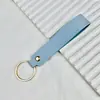 Chaveiro de PU de cor sólida transfronteiriço, cordão de mão de couro de cor doce criativo, chaveiro de carro simples para homens, atacado