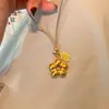 Collar con Colgante de Flor Dorada Hueca Pequeña de la Fortuna con Dinero y Flor de Buena Suerte Cadena para Suéter de la Tienda de Oro Pu Zuo