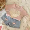 Conjunto de Verano para Niñas 2026 Nuevo Estilo Coreano Infantil Moderno Lazo Shorts de Mezclilla Rosa de Manga Corta Conjunto de Dos Piezas