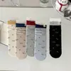 Calcetines nuevos para mujer de otoño e invierno hasta la pantorrilla, algodón peinado, con etiqueta de tela de cachorro, estilo coreano, sin costuras, hechos en Zhuji, al por mayor