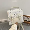 Mochila pequeña con estampado de lazos estilo universitario 2026 moda nueva tendencia versión coreana elegante casual mochila de viaje