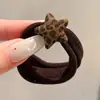 Coloridos coleteros de nuevo estilo 2026, versátiles y dulces, con accesorios de M&M's, anillos de toalla, diseños de dibujos animados y un estilo fresco y lindo, perfectos para accesorios para el cabello de niños