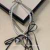 Collar con colgante de amor de metal dulce de verano con lazo y perlas para mujer, cadena de clavícula elegante y fresca.