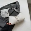 Textura francesa bolso popular de hombro axilar para mujer 2023 nuevo moderno color sólido nicho francés portátil bolso baguette francés