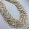 Suministro del fabricante de perlas naturales de agua dulce ultrapequeñas, sin perforar, de 2-2.5 mm para manualidades, un hilo mide aproximadamente 39 cm de largo.