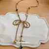 Novo colar de contas de vidro com laço doce estilo coreano para mulheres, corrente para clavícula de design versátil, corrente de suéter da moda para mulheres