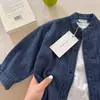 Camisa de Mezclilla Suave para Niños Otoño 2026 Nuevo Modelo Manga Larga para Niños y Niñas Camisa Chaqueta Oso Bebé Cuello Redondo