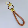 Llavero de cuerda trenzada de cuero PU con hebilla de langosta redonda, llavero de amor para hombres y mujeres, cuerda de mano para bolsa, cordón para el cuello, venta al por mayor directa de fábrica