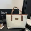 Bolsa tote de patchwork de linho estilo universitário europeu e americano de comércio exterior com pingente de pelúcia fofo, bolsa de ombro, bolsa tote elegante